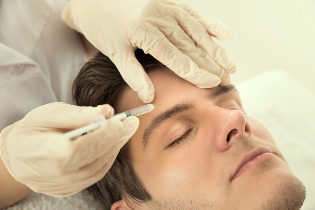 Aesthetic practitioner administering a facial injectable treatment in a UK clinical setting